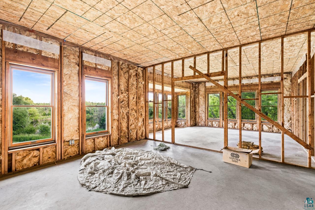 4800 Tower Road Moose Lake, MN 55767 - Photo 69 of 83 Framed interior space featuring multiple window openings, oriented strand board walls and ceiling, and a concrete floor