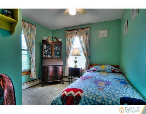 608 Ridge Road Monmouth Junction, NJ 08852 - Photo 11 of 16 a bedroom with furniture and a window