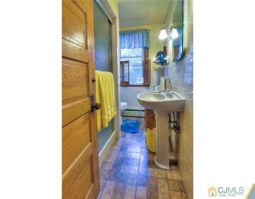 608 Ridge Road Monmouth Junction, NJ 08852 - Photo 12 of 16 a bathroom with a sink and mirror