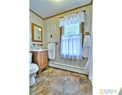 608 Ridge Road Monmouth Junction, NJ 08852 - Photo 13 of 16 a bathroom with a sink toilet and shower