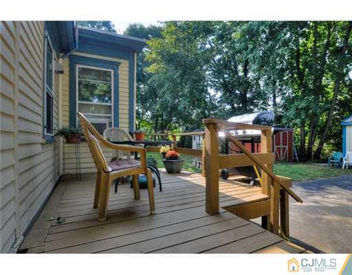 608 Ridge Road Monmouth Junction, NJ 08852 - Photo 15 of 16 a view of a deck with table and chairs with wooden floor and fence