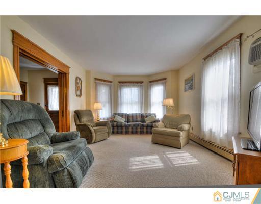 608 Ridge Road Monmouth Junction, NJ 08852 - Photo 4 of 16 a living room with furniture and a flat screen tv