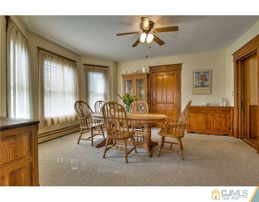 608 Ridge Road Monmouth Junction, NJ 08852 - Photo 5 of 16 a living room with furniture a chandelier and a window