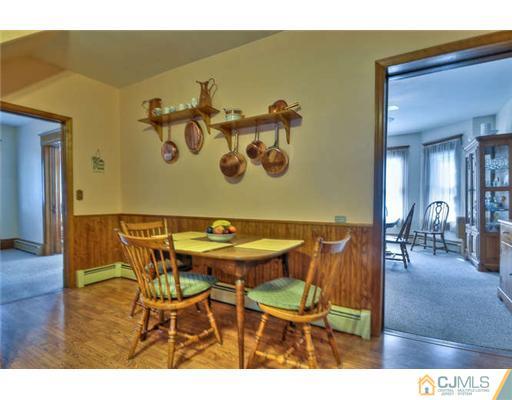 608 Ridge Road Monmouth Junction, NJ 08852 - Photo 7 of 16 a view of a dining room with furniture and wooden floor
