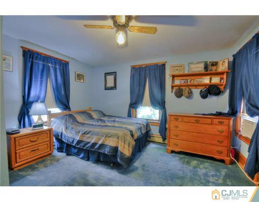 608 Ridge Road Monmouth Junction, NJ 08852 - Photo 9 of 16 a bedroom with a bed and a dresser