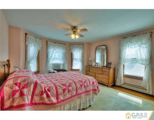 608 Ridge Road Monmouth Junction, NJ 08852 - Photo 10 of 16 a bedroom with a bed and a large mirror with window