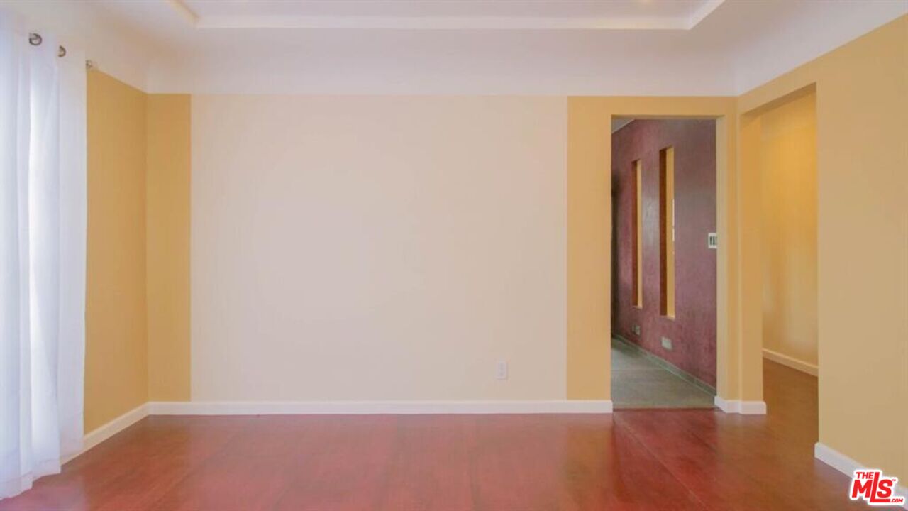 1437 South Ridgeley Drive Los Angeles, CA 90019 - Photo 19 of 37 a view of a hallway with wooden floor