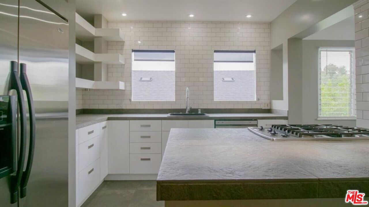 1437 South Ridgeley Drive Los Angeles, CA 90019 - Photo 20 of 37 a bathroom with a sink and a mirror
