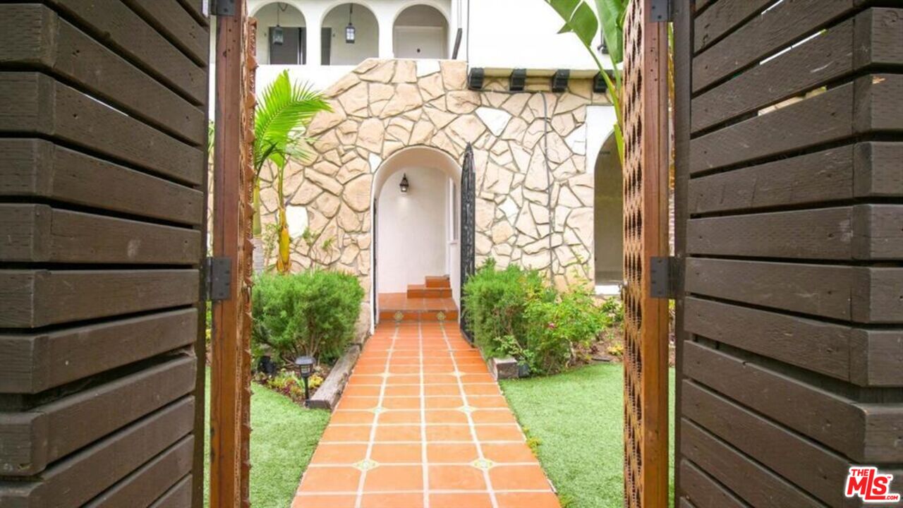 1437 South Ridgeley Drive Los Angeles, CA 90019 - Photo 2 of 37 a front view of a house with garden