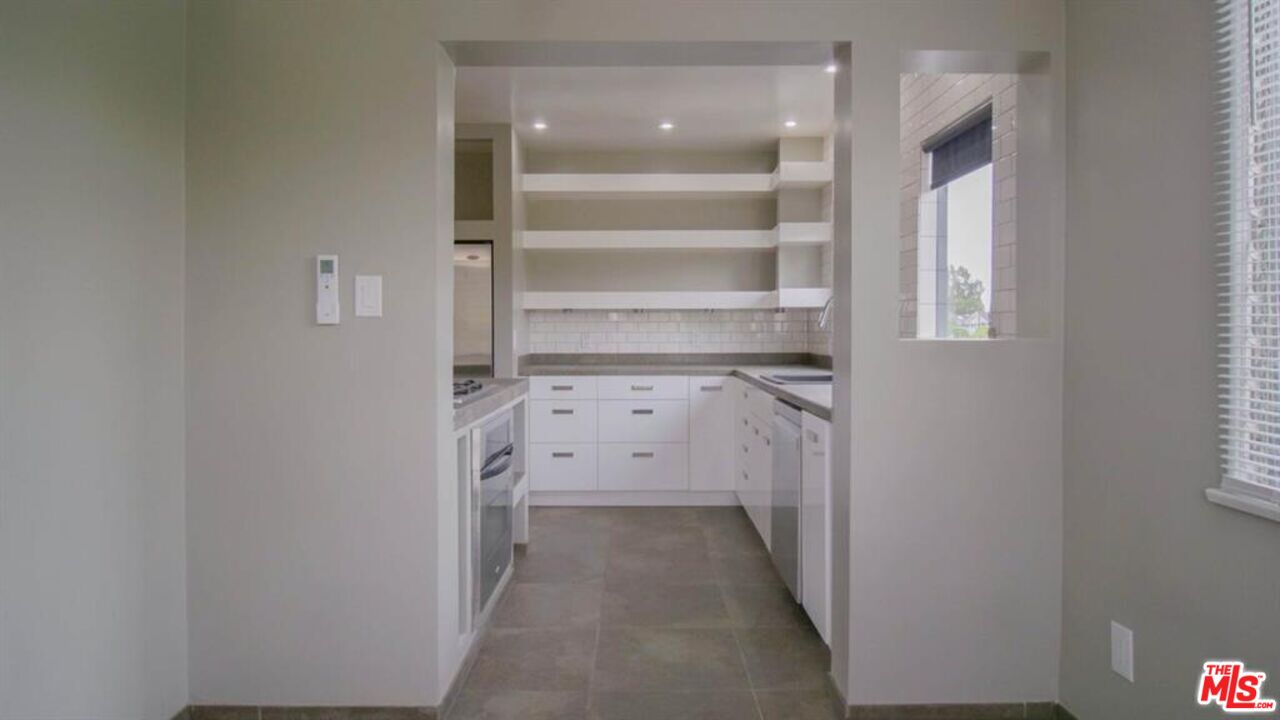 1437 South Ridgeley Drive Los Angeles, CA 90019 - Photo 22 of 37 a view of a hallway with closet