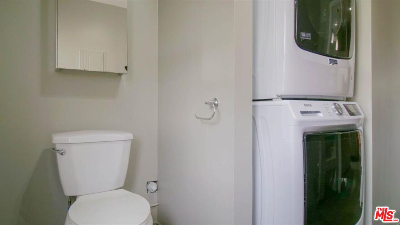 1437 South Ridgeley Drive Los Angeles, CA 90019 - Photo 25 of 37 a white toilet sitting next to a shower