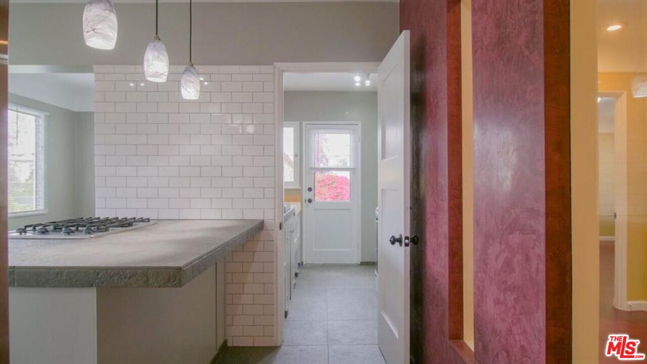 1437 South Ridgeley Drive Los Angeles, CA 90019 - Photo 26 of 37 a bathroom with a sink vanity and a mirror