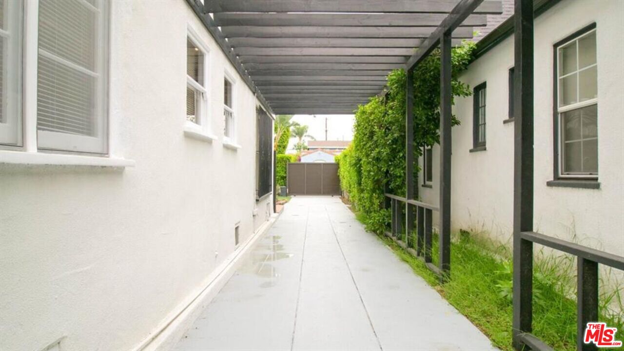 1437 South Ridgeley Drive Los Angeles, CA 90019 - Photo 4 of 37 a view of a pathway of a house with a porch