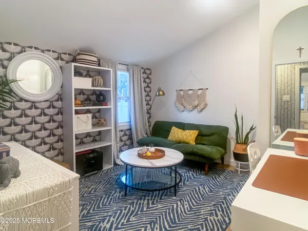 a bedroom with a bed and a mirror on dresser