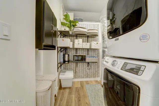 a view of washer and dryer with kitchen in the background