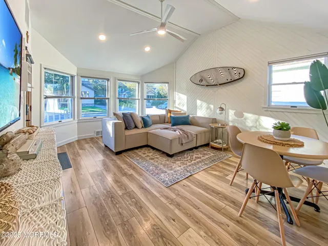 a view of a patio with a table and chairs under an umbrella