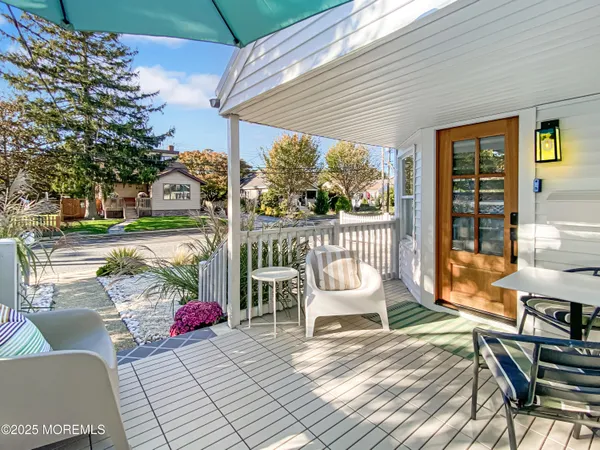 a view of a patio with a table and chairs under an umbrella