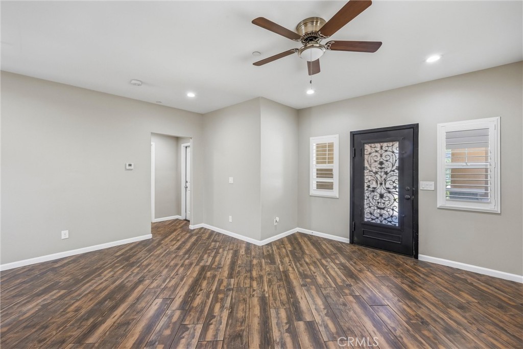 956 West Tibbot Street Rialto, CA 92377 - Photo 3 of 37 a view of a big room with wooden floor and windows