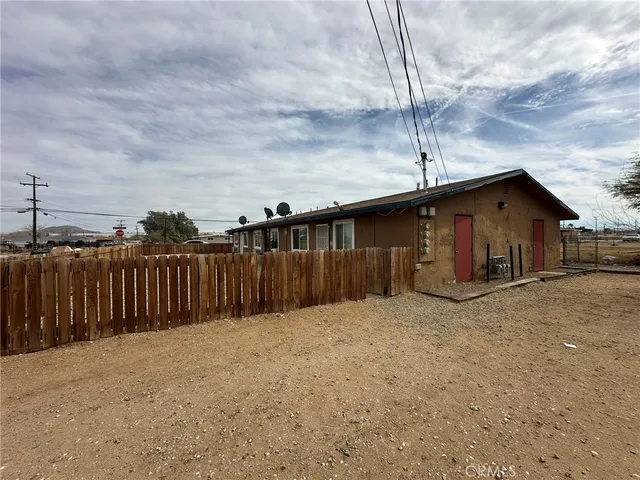 a front view of house with wooden fence
