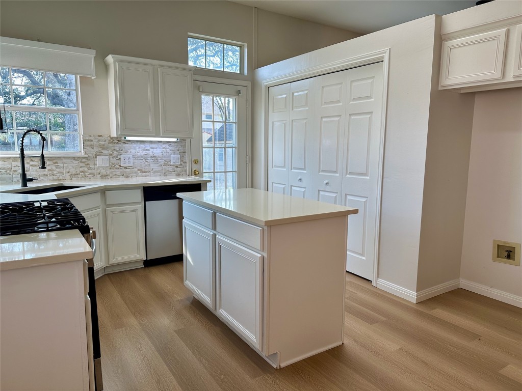 104 Benchmark Street Georgetown, TX 78626 - Photo 13 of 39 a kitchen with stainless steel appliances granite countertop a sink stove and refrigerator