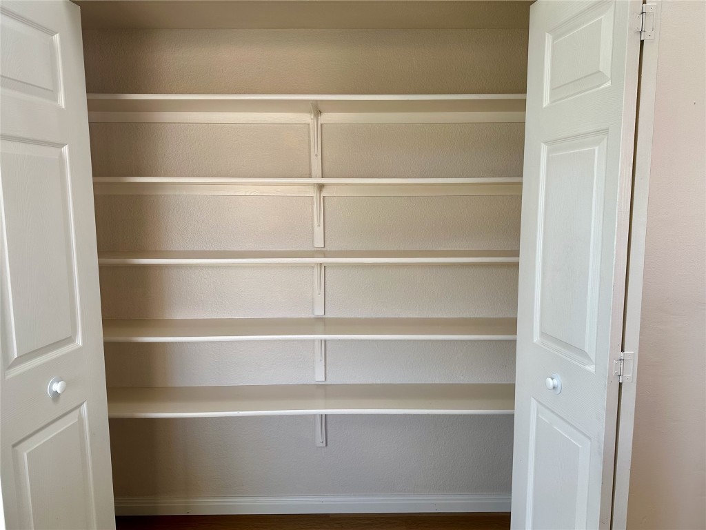 104 Benchmark Street Georgetown, TX 78626 - Photo 15 of 39 a view of a walk in closet with empty racks