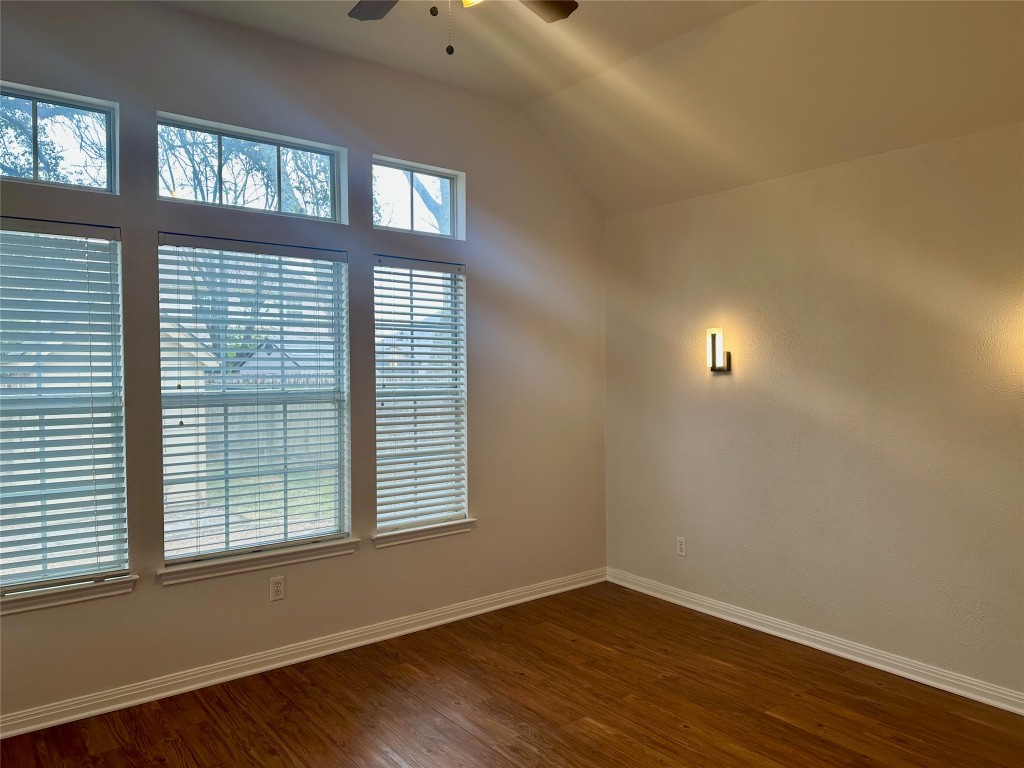104 Benchmark Street Georgetown, TX 78626 - Photo 16 of 39 a view of an empty room with wooden floor and a window