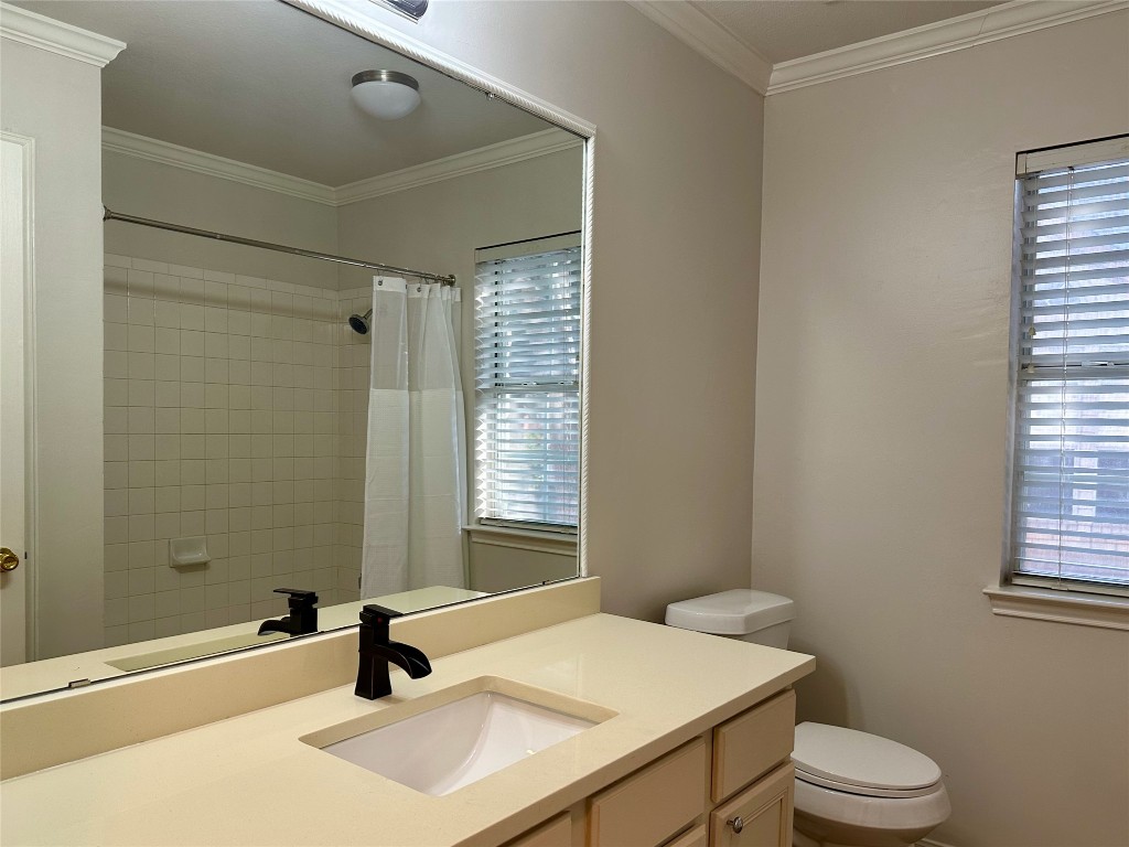 104 Benchmark Street Georgetown, TX 78626 - Photo 25 of 39 a bathroom with a sink toilet a mirror and shower