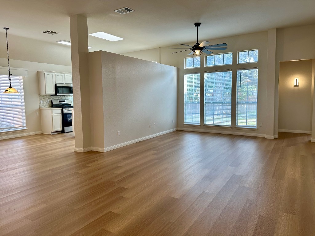 104 Benchmark Street Georgetown, TX 78626 - Photo 3 of 39 a view of a kitchen with wooden floor and a kitchen