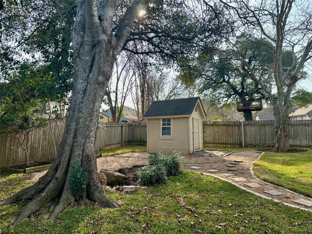 104 Benchmark Street Georgetown, TX 78626 - Photo 35 of 39 a view of a backyard with plants and large tree