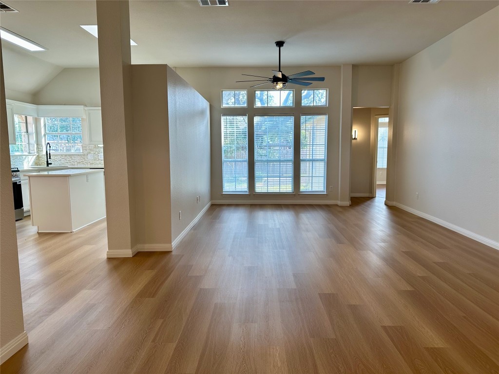 104 Benchmark Street Georgetown, TX 78626 - Photo 4 of 39 a view of an empty room with wooden floor and a window