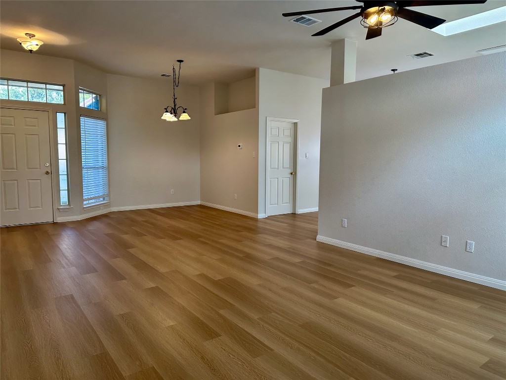 104 Benchmark Street Georgetown, TX 78626 - Photo 5 of 39 an empty room with wooden floor and windows