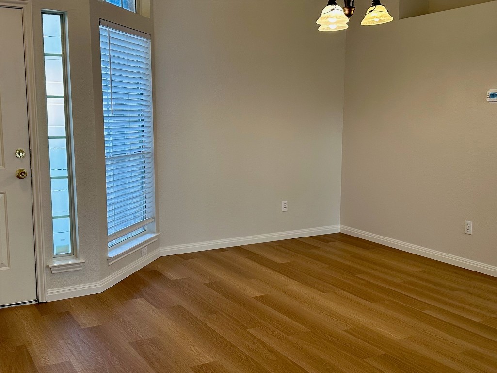 104 Benchmark Street Georgetown, TX 78626 - Photo 6 of 39 a view of an empty room with wooden floor and a window