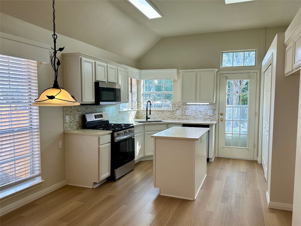 104 Benchmark Street Georgetown, TX 78626 - Photo 8 of 39 a kitchen with a sink appliances cabinets and a wooden floor