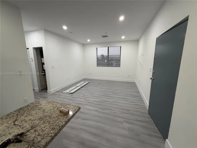 an entryway in a hall with wooden floor