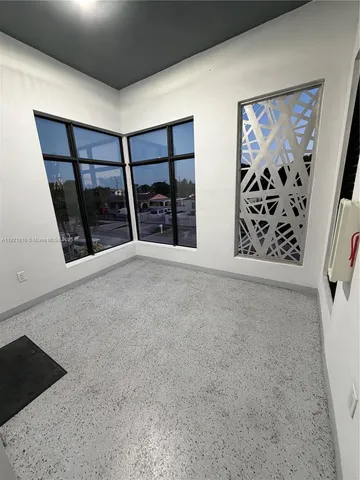 a view of an empty room and wooden floor