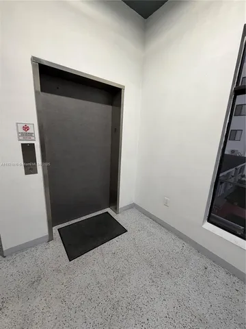 a view of an empty room and a window