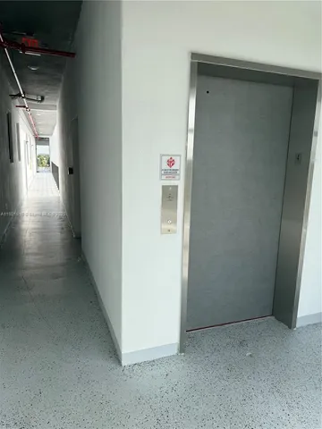 a view of hallway with wooden floor