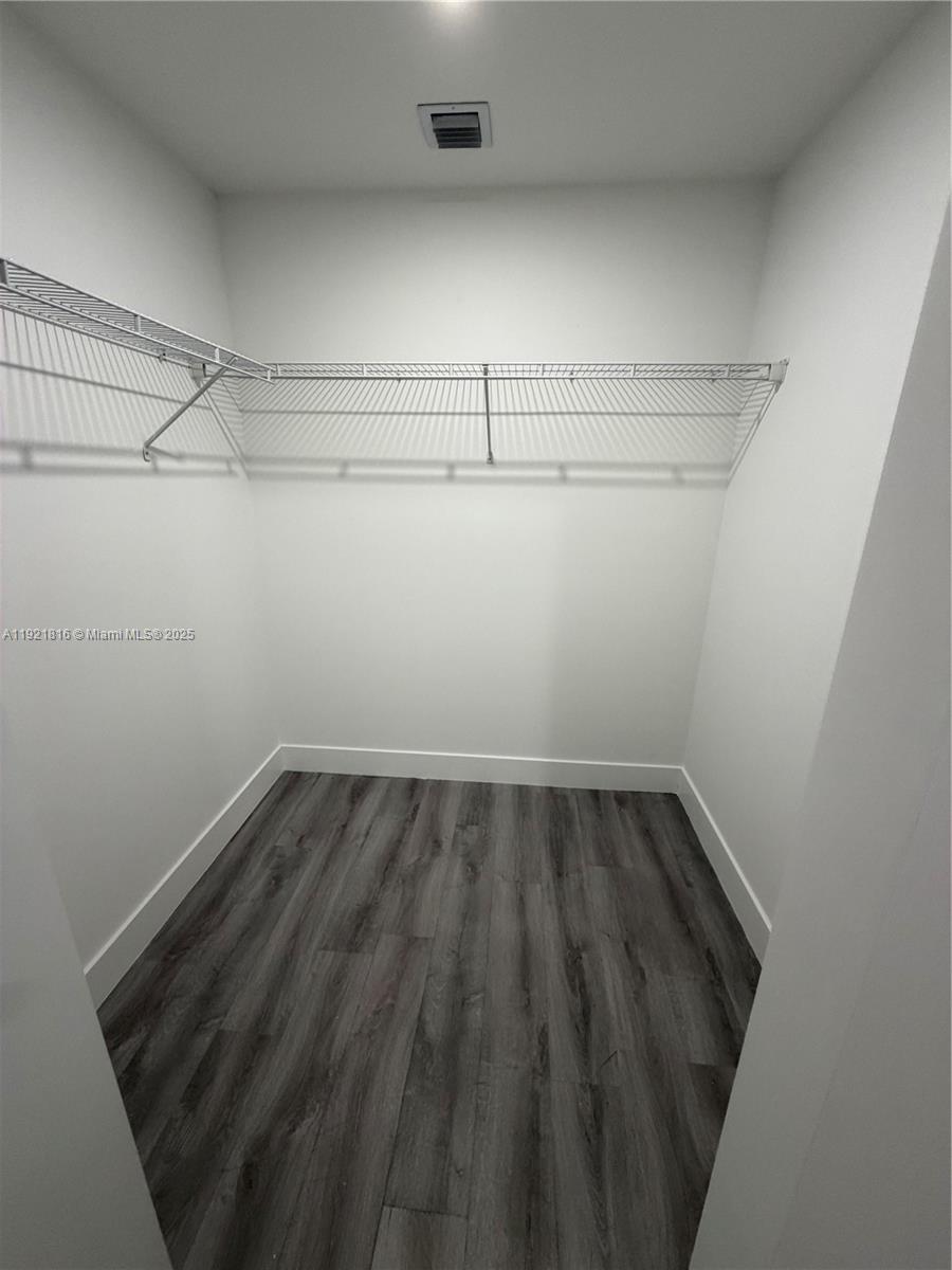 859 East 24th Street, Unit 402 Hialeah, FL 33013 - Photo 8 of 22 a view of a room with racks on the wall