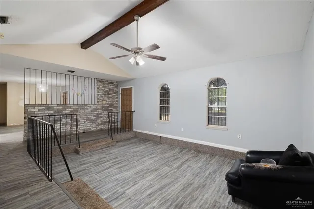 a view of a livingroom with furniture and ceiling fan