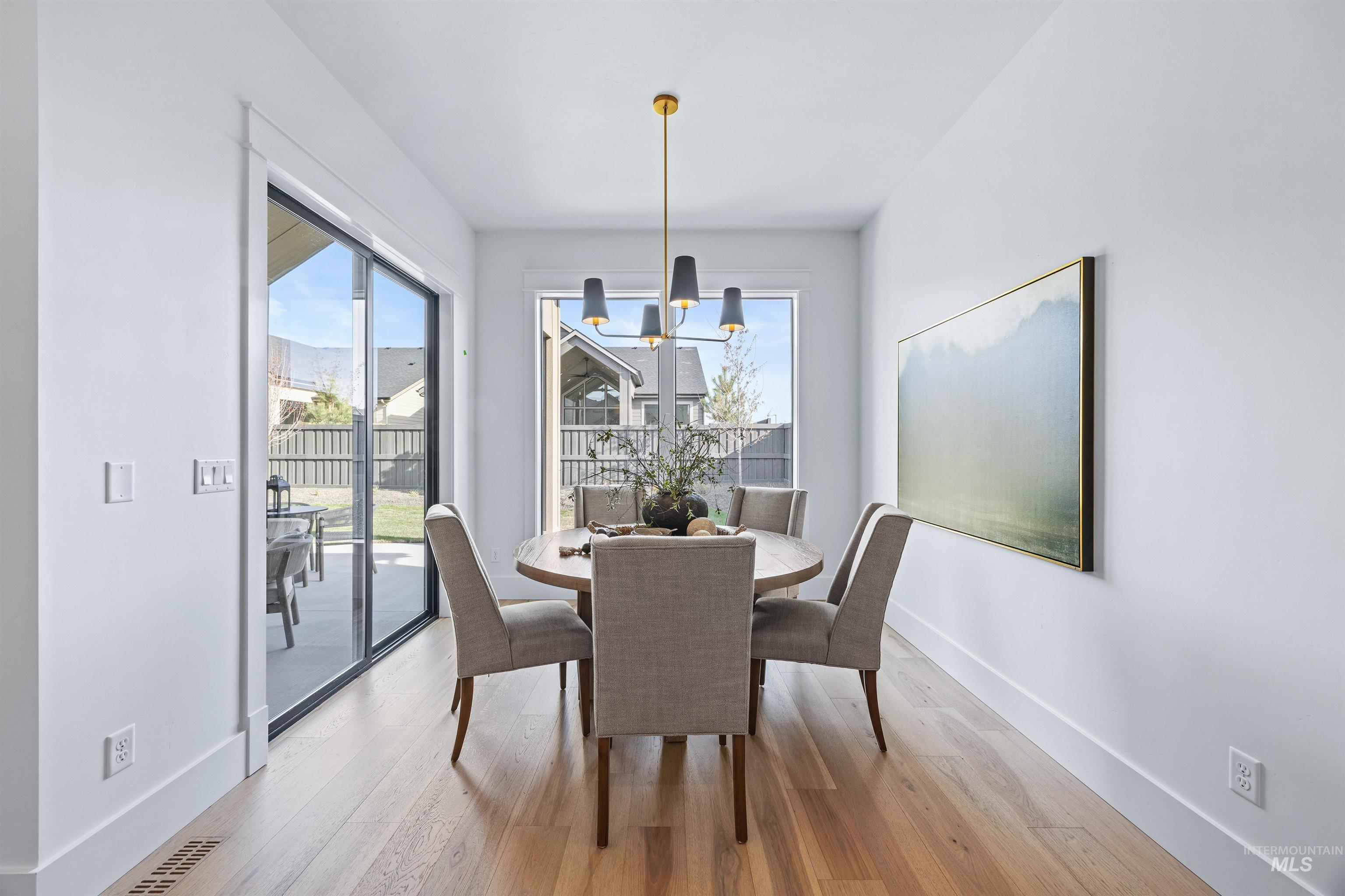 948 East Escalation Street Meridian, ID 83642 - Photo 14 of 44 Dining room with suspended lighting and light wood finished floors