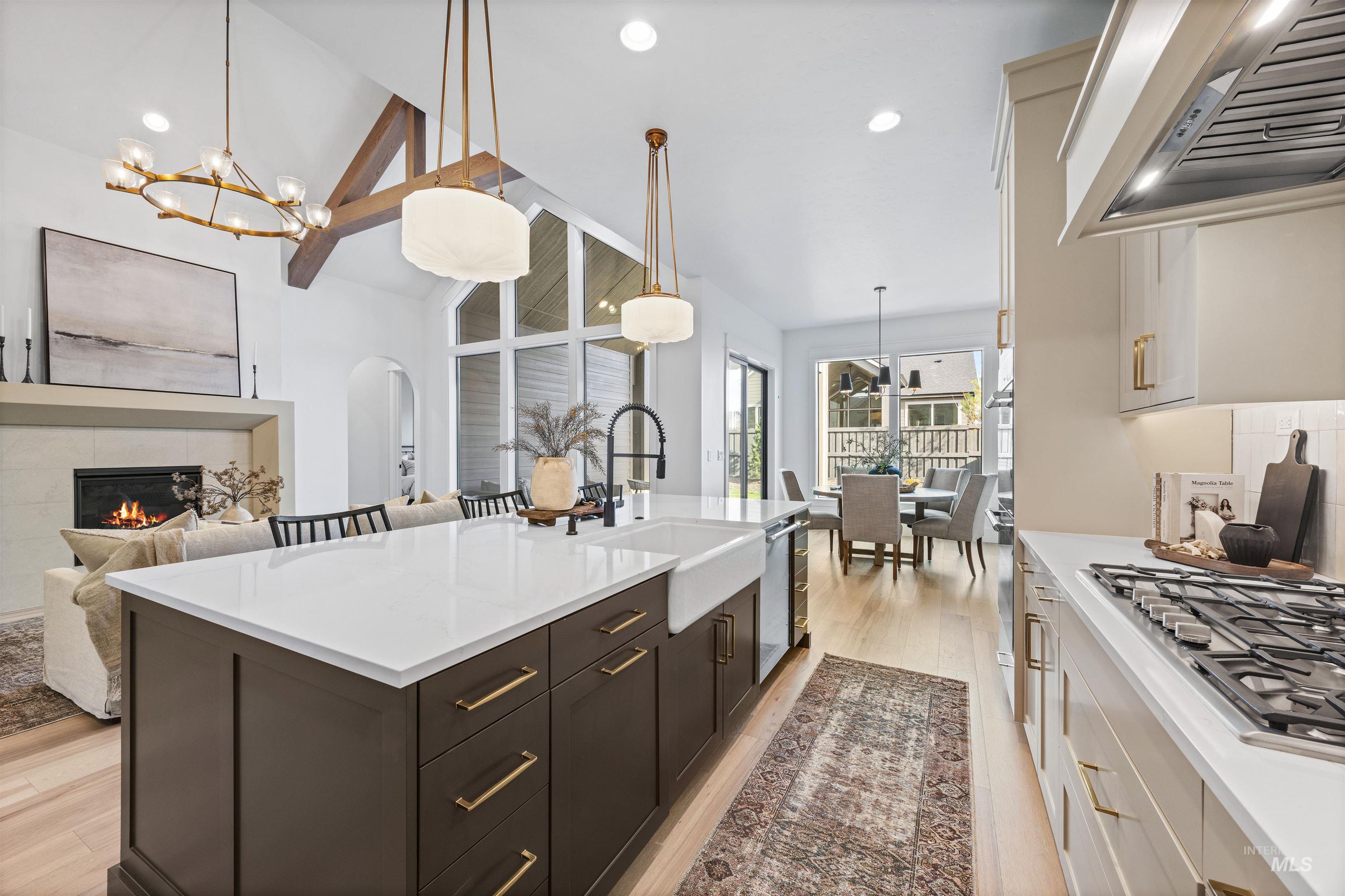 948 East Escalation Street Meridian, ID 83642 - Photo 44 of 44 Dual tone kitchen featuring two tone color scheme, range hood, lofted ceiling, arched walkways, and open floor plan