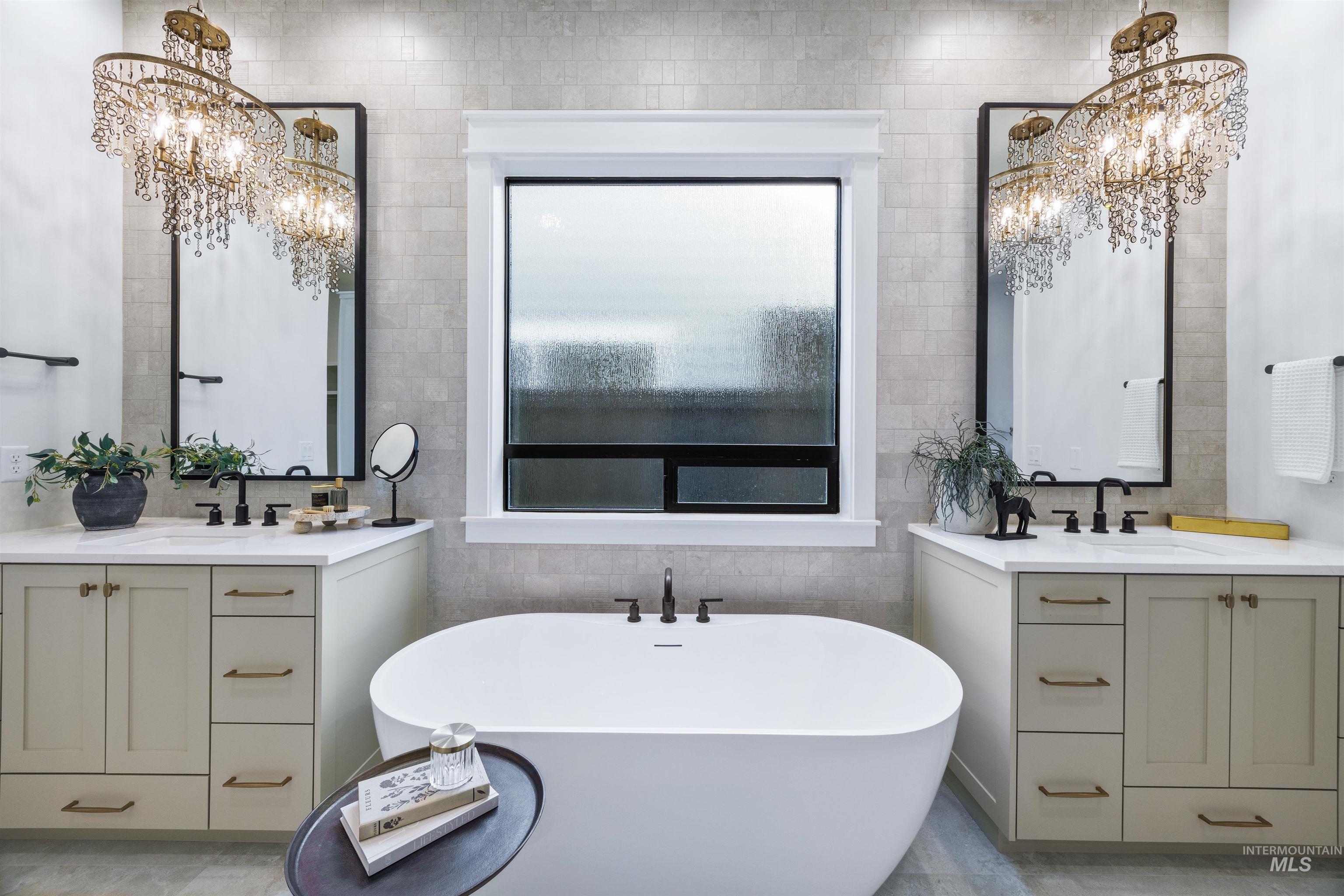948 East Escalation Street Meridian, ID 83642 - Photo 26 of 44 Full bath with two vanities, tile walls, hanging lights, and a soaking tub