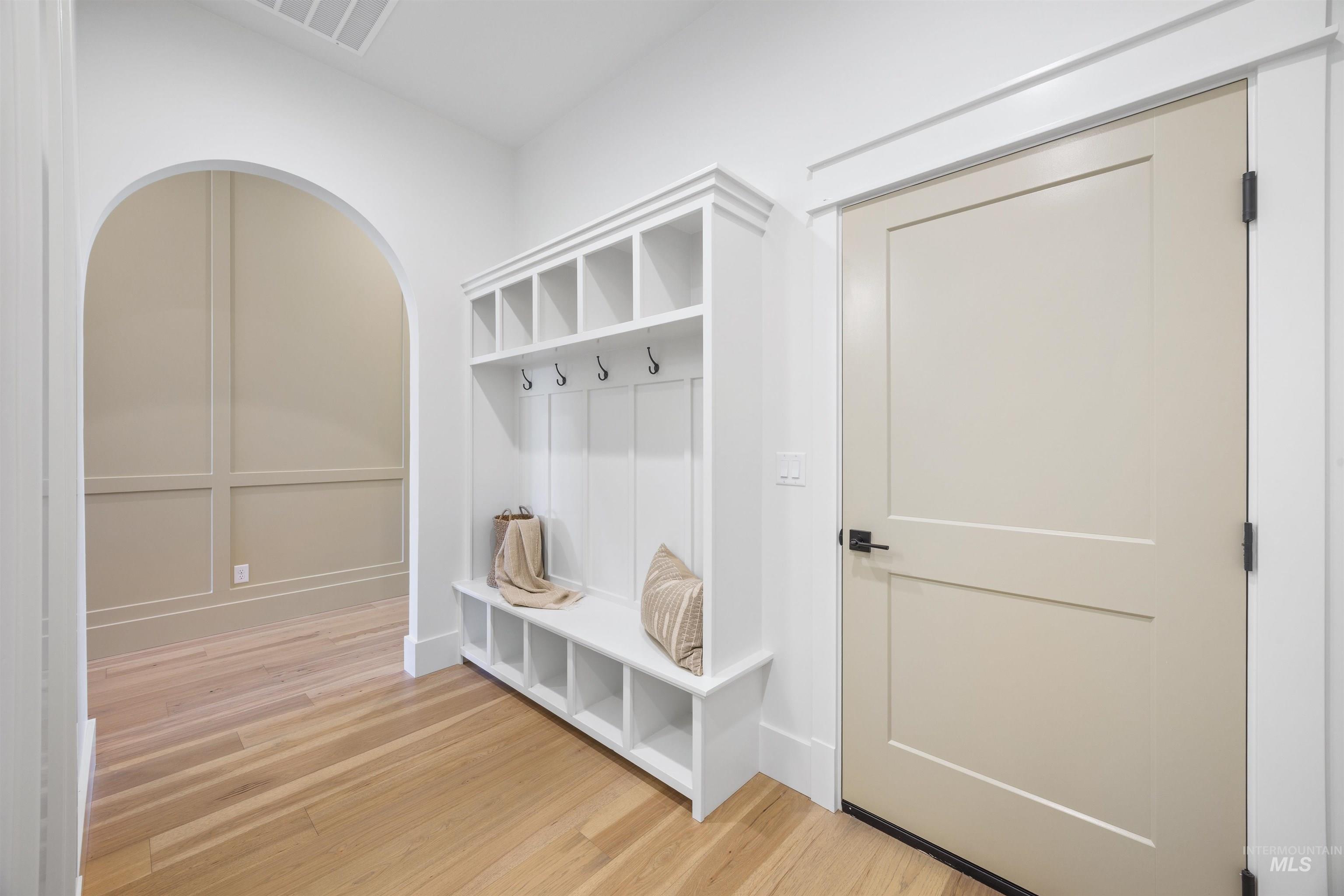 948 East Escalation Street Meridian, ID 83642 - Photo 33 of 44 Mudroom featuring light wood-style floors and arched walkways
