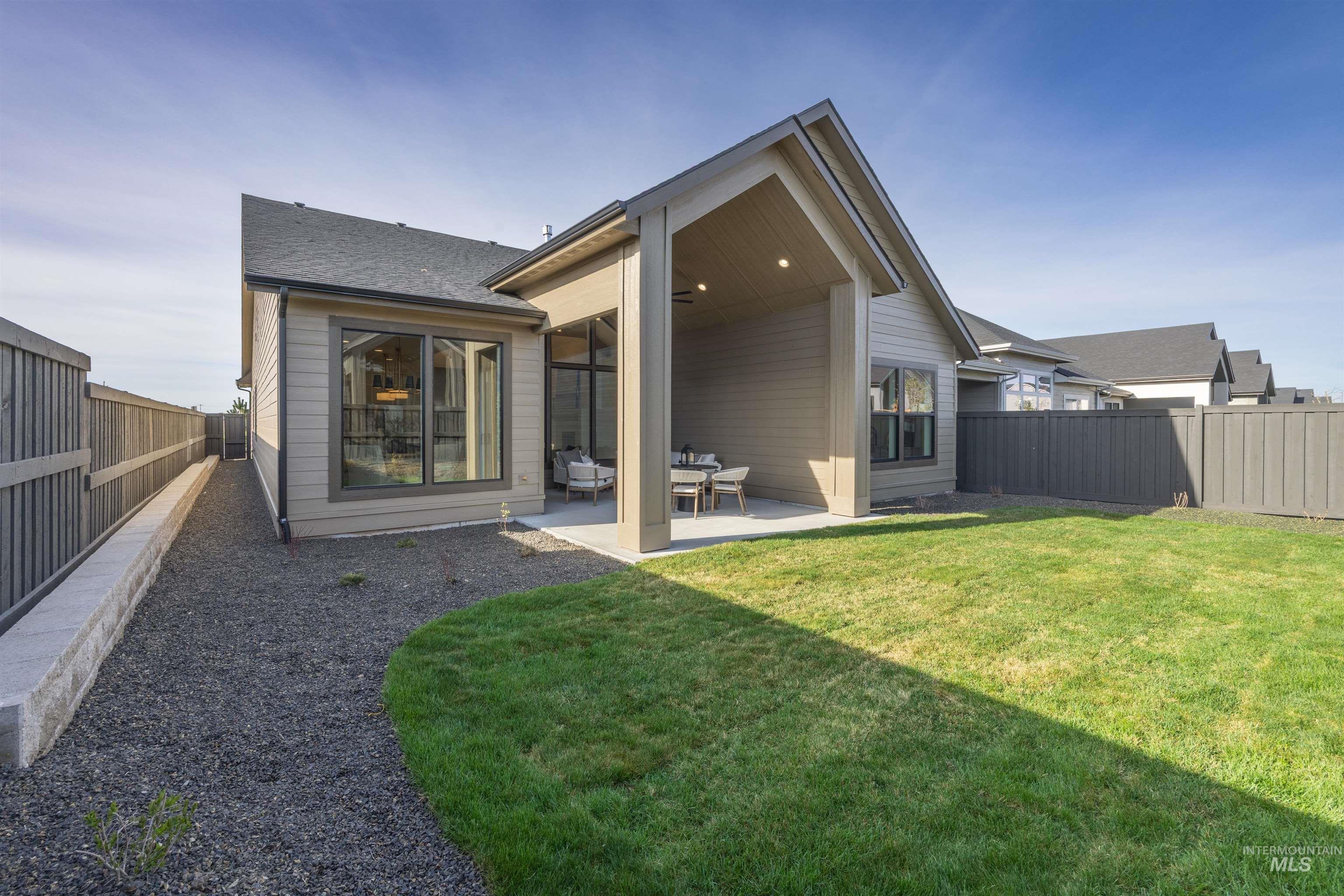 948 East Escalation Street Meridian, ID 83642 - Photo 37 of 44 Rear view of property with a fenced backyard, a patio area, and a shingled roof