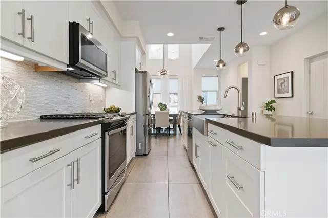 a living room with furniture a window and a chandelier