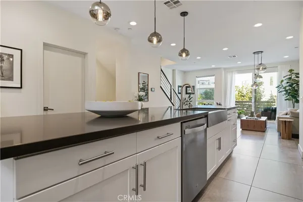 a kitchen with stainless steel appliances kitchen island granite countertop a sink and cabinets