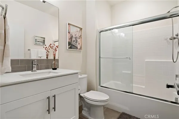 a bedroom with a bed and a potted plant