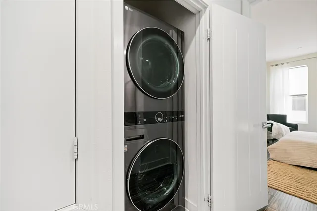 a bedroom with a large bed and wooden floor