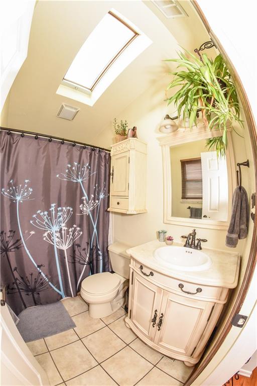 1107 Rankin Road White Oak, PA 15131 - Photo 10 of 21 Attractive upstairs full bath has bath/shower and sky light that brings in plenty of natural light.
