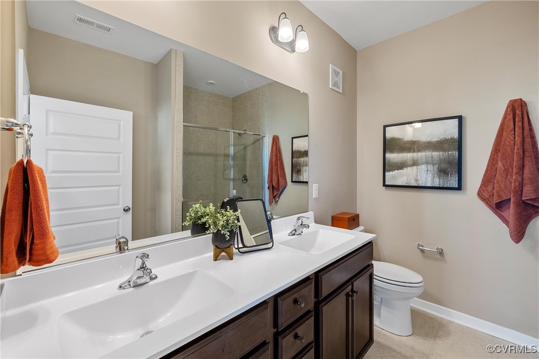 4112 Ebbies Crossing Midlothian, VA 23112 - Photo 14 of 38 a bathroom with a toilet a sink and a large mirror
